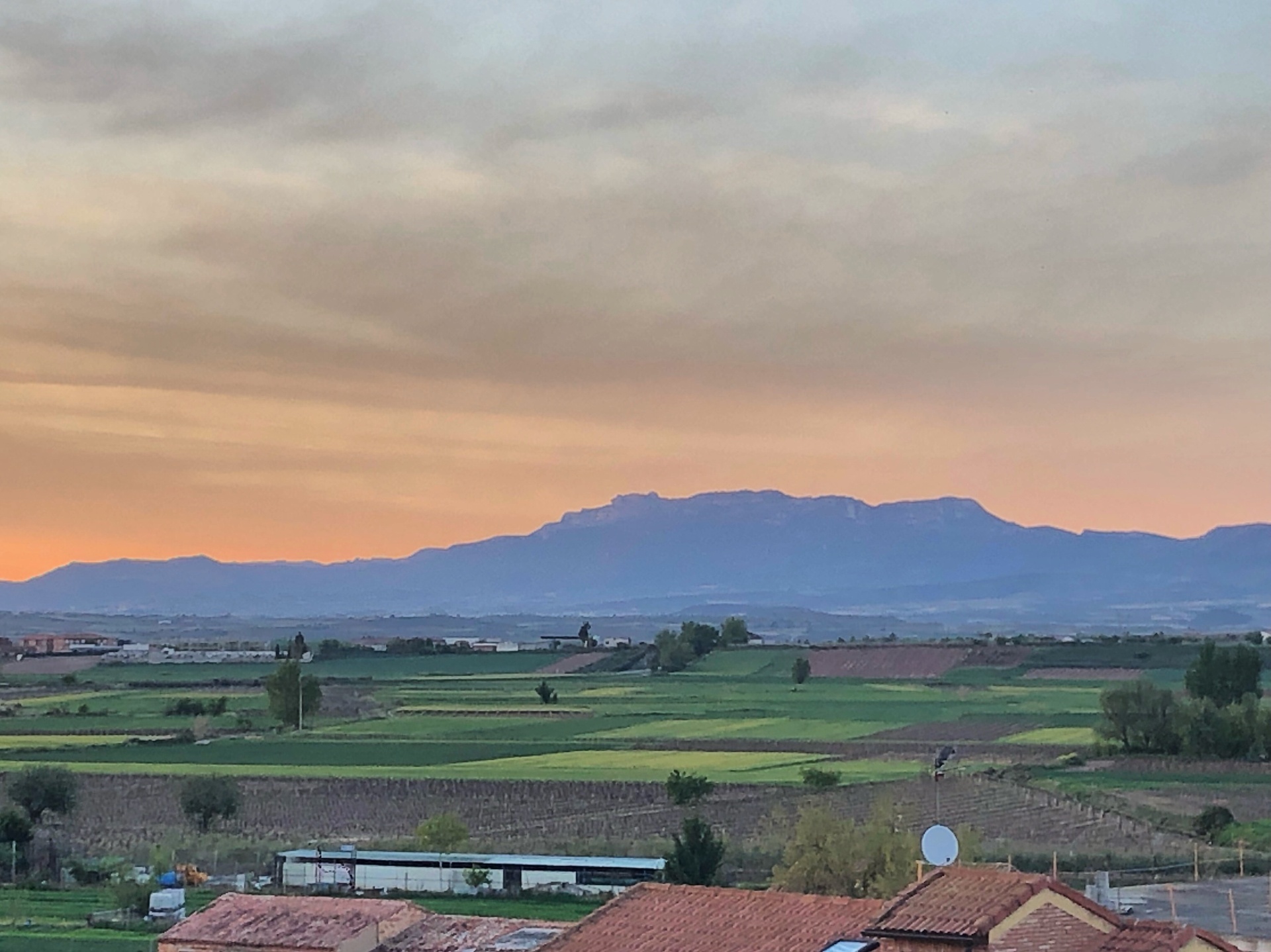 Sunset over the fields and mountains of Laura's homeland
